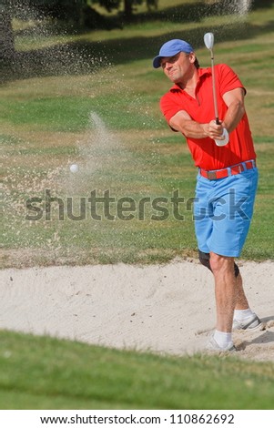 golfer swing at the ball with sand