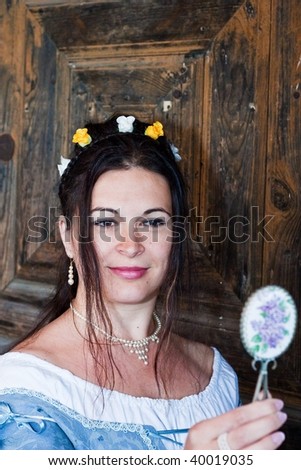 woman in historical costume with small mirror