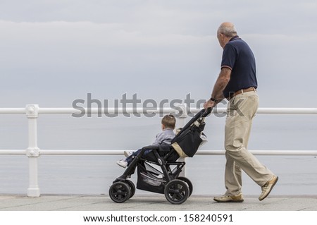 Old man with baby stroller