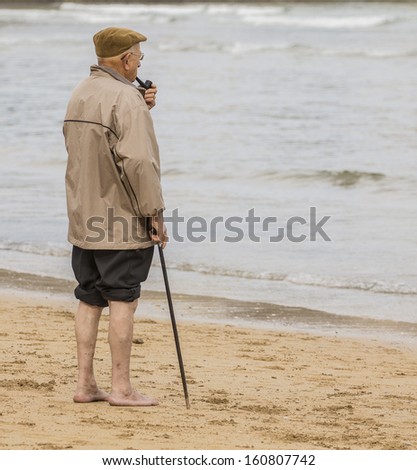 Old man smoking a pipe waterfront