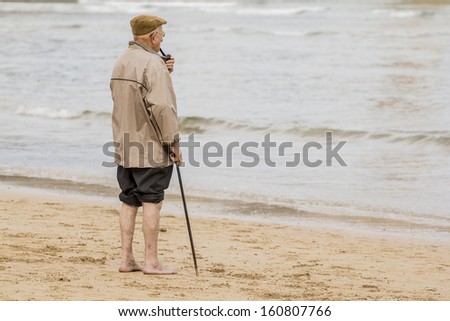 Old man smoking a pipe waterfront