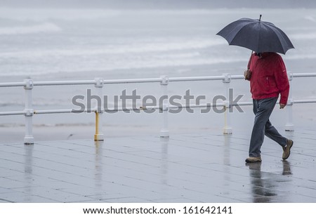 Man with umbrella walking in the rain