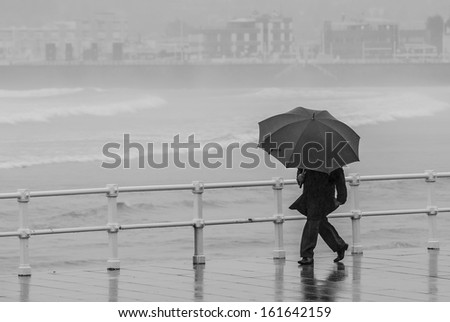 Man with umbrella walking in the rain