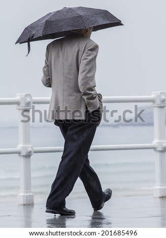 Man with umbrella walking through the city