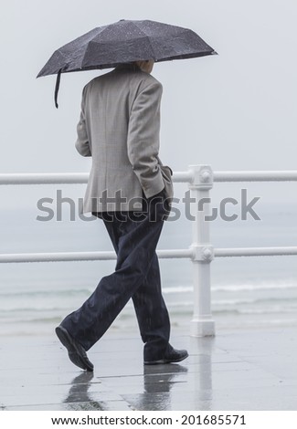 Man with umbrella walking through the city
