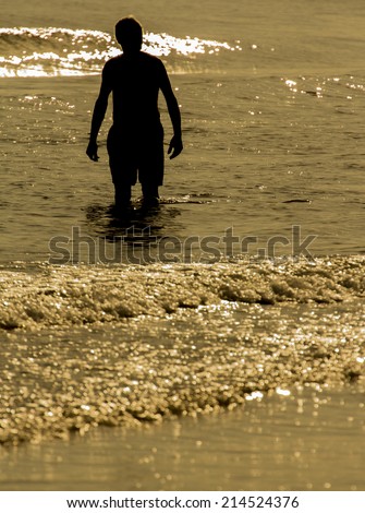 Old man walking by the sea shore