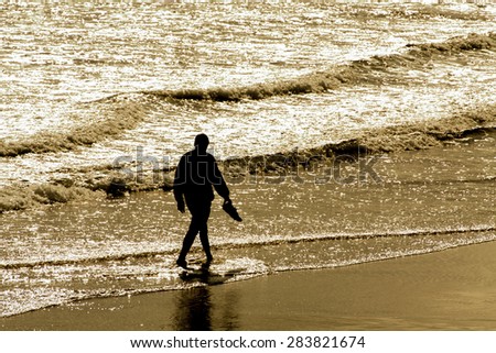 Man walking along the seashore