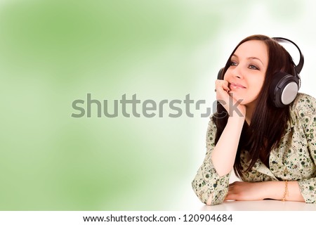 photo of attractive woman with headphones in front of a green background