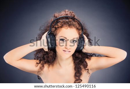 photo of sexy female woman with great curly hairs and headphones - deejay