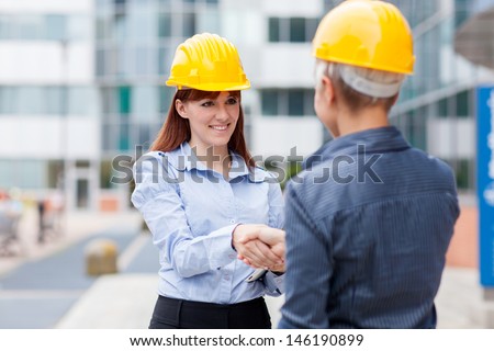 Photo of two female constructors meet each other