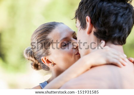 Young couple in love kisses each other