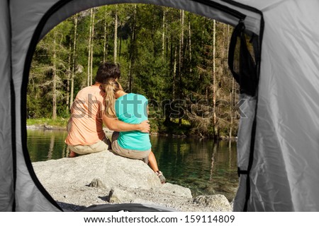 Conceptual View of a couple that camps from the inside of a tent