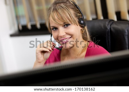 Photo of blonde receptionist working in the office