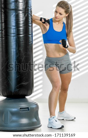 Photo of sexy blonde woman in a gym club doing fit box