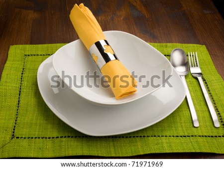 photo of wood table with dishes which is ready to be seated for lunch
