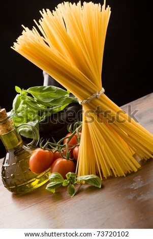 photo of different ingredients for italian pasta with tomatoes and basil