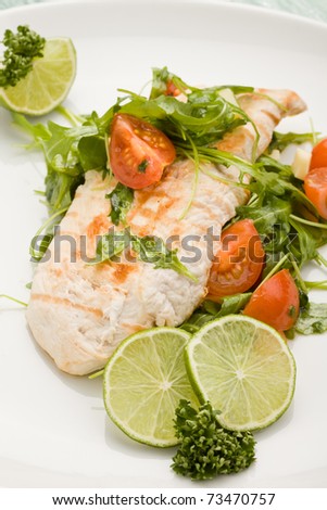 photo of grilled chicken breast with fresh green rocket salad