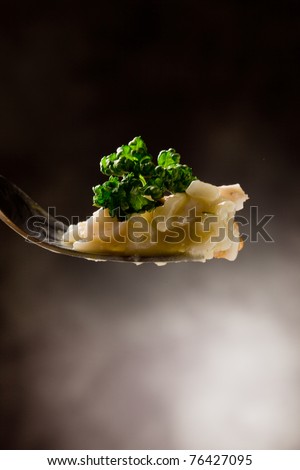 photo fork holding delicious risotto with seafood and parsley on it
