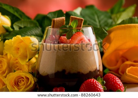 chocolate hazelnut mousse with berries in front of a rose background