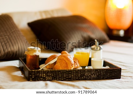 photo of tray with breakfast food on the bed inside a bedroom
