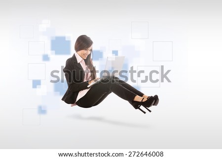 Asian smiling businesswoman with notebook is sitting on the floor over white isolated background