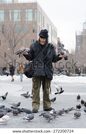 NEW YORK CITY - MARCH 8th 2015: Birdman of Washington Square Park/ Larry feeds birds and pigeons at the park