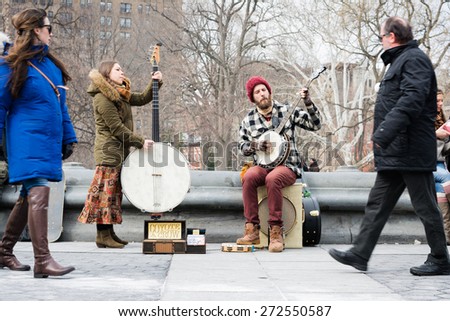NEW YORK CITY - MARCH 8th 2015: young artist plays music performance in Washington Square Park, Manhattan, USA