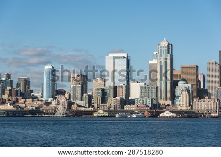 A view of Seattle downtown, Business district, Space Needle and blue ocean under a clear blue sky from Alki beach