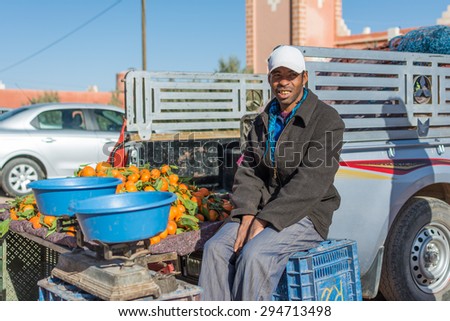 Marrakesh, Morocco: Dec 30th 2014: An unidentified Moroccan man selling oranges on his stuck in the street market, Marrakesh Morocco