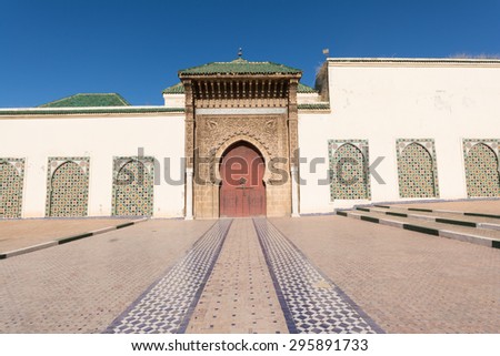 Red traditional Moroccan style gate at royal palace entrance, Morocco