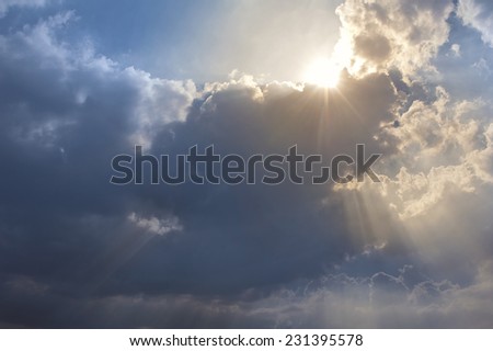 Sun rise above the clouds. The ray of lights shine through the clouds