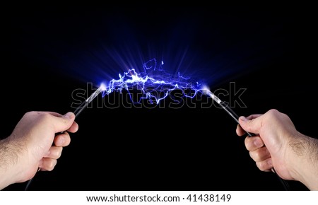 Stock image of  hands holding live electric cables