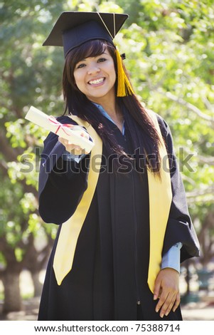 Stock image of happy female graduate, outdoor setting