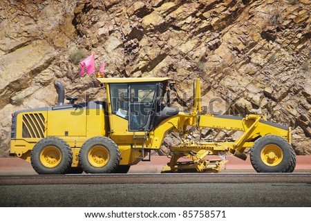 Stock image of motor grader working on road construction