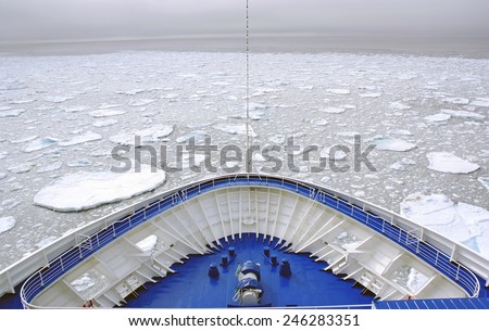 Cruise Ship bow passing icy snow arctic waters near Spitsbergen, Svalbard, Norway