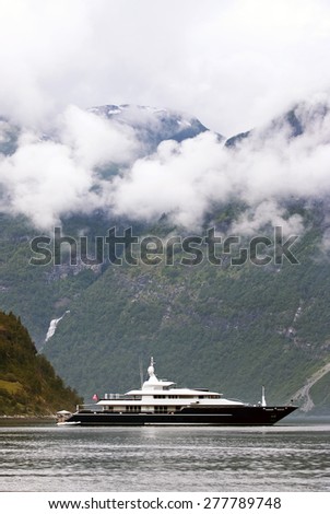 Tourism vacation and travel. Small yacht with mountains and fjord NÃ¦rÃ¸yfjord in Gudvangen, Norway, Scandinavia.