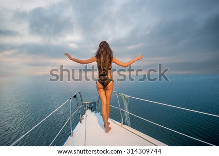 Girl resting on the sea. Relax on a yacht. Yacht in the open sea. Traveling on a yacht.
