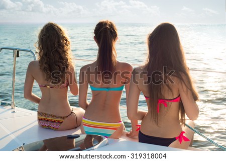 Beautiful girl relaxing on a yacht. Yachting on the sea. Girls at the resort. Traveling on a yacht on the ocean. Tourists rest on a yacht. Relax on the yacht.