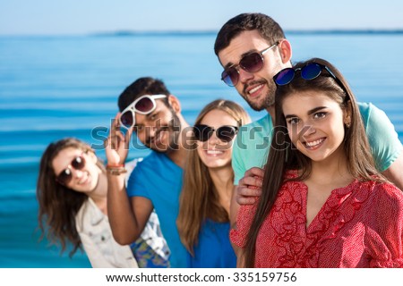 Friends spend a weekend at sea. Beautiful youth smiling. Vacations on the sea. Students are on vacation. Happy people.