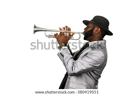Bearded musician. Classy jazzman. A gifted trumpet player. Stylish musician with a trumpet.