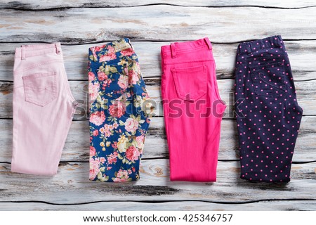 Floral and pink folded pants. Woman\'s trousers of bright color. Low price and free delivery. Colors and patterns.
