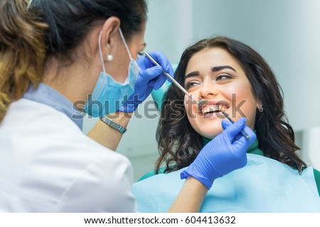Woman at the dentist smiling. Work of stomatologist with patient. Make your smile perfect.
