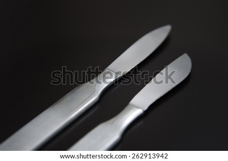 two scalpel on a black matte background
