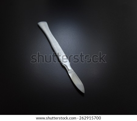 surgical scalpel on a black matte background
