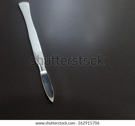 surgical scalpel on a black matte background