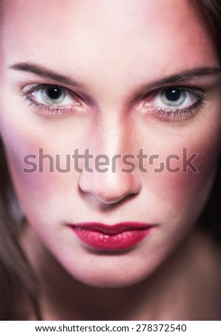 evil portrait of a young girl. Not happy woman\'s face with green eyes