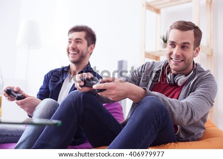 Attractive two men are making fun with play-station