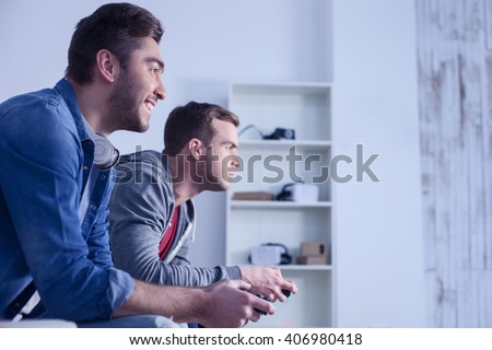 Attractive two guys are competing in play station