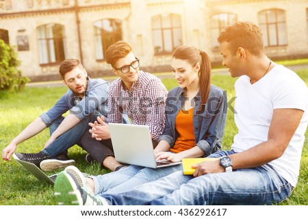 Happy young students are chatting in campus