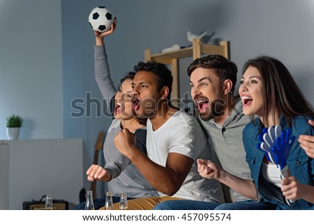 Group of friends watching sport together